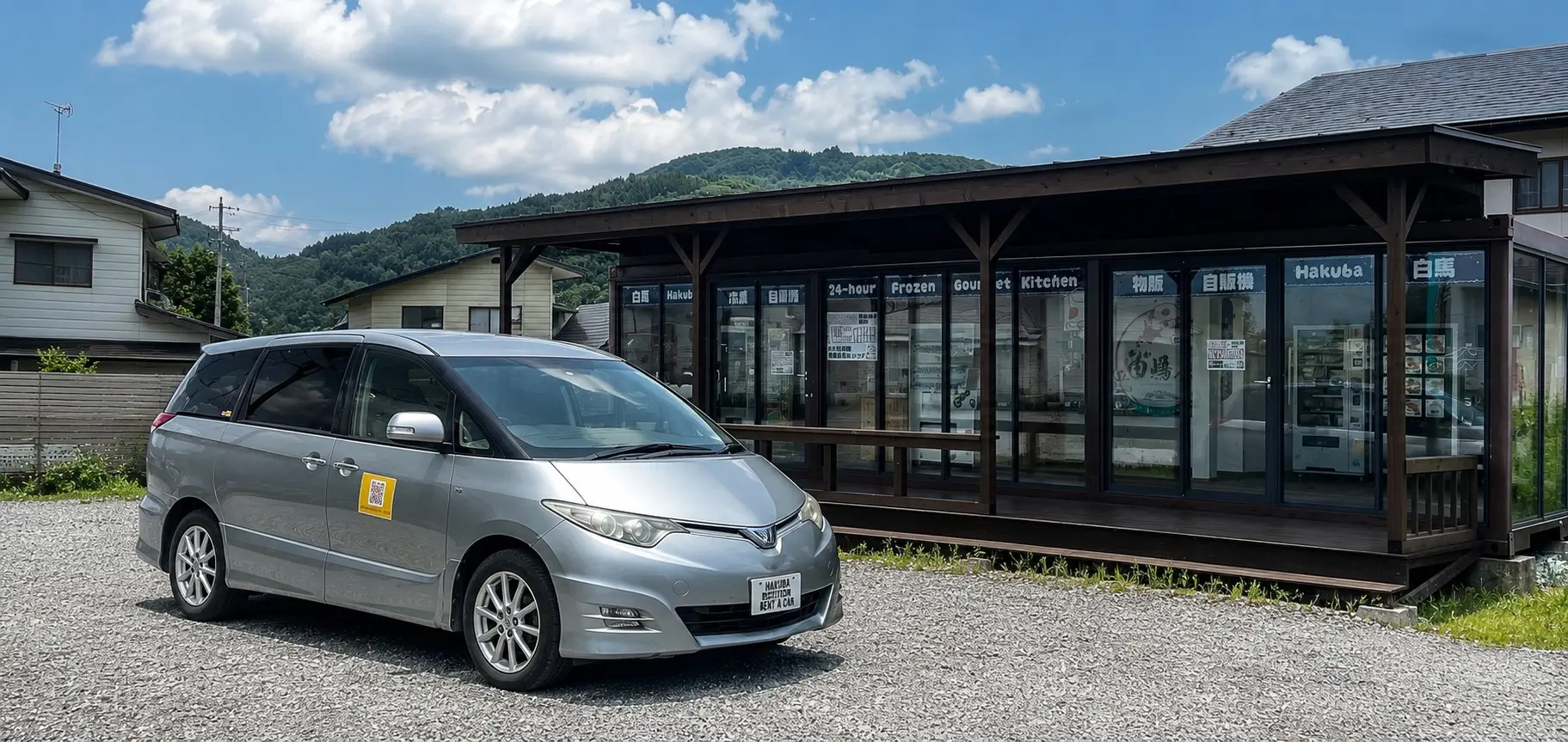白馬駅前に停車した白馬ステーションレンタカーの4WD車両と白馬三山